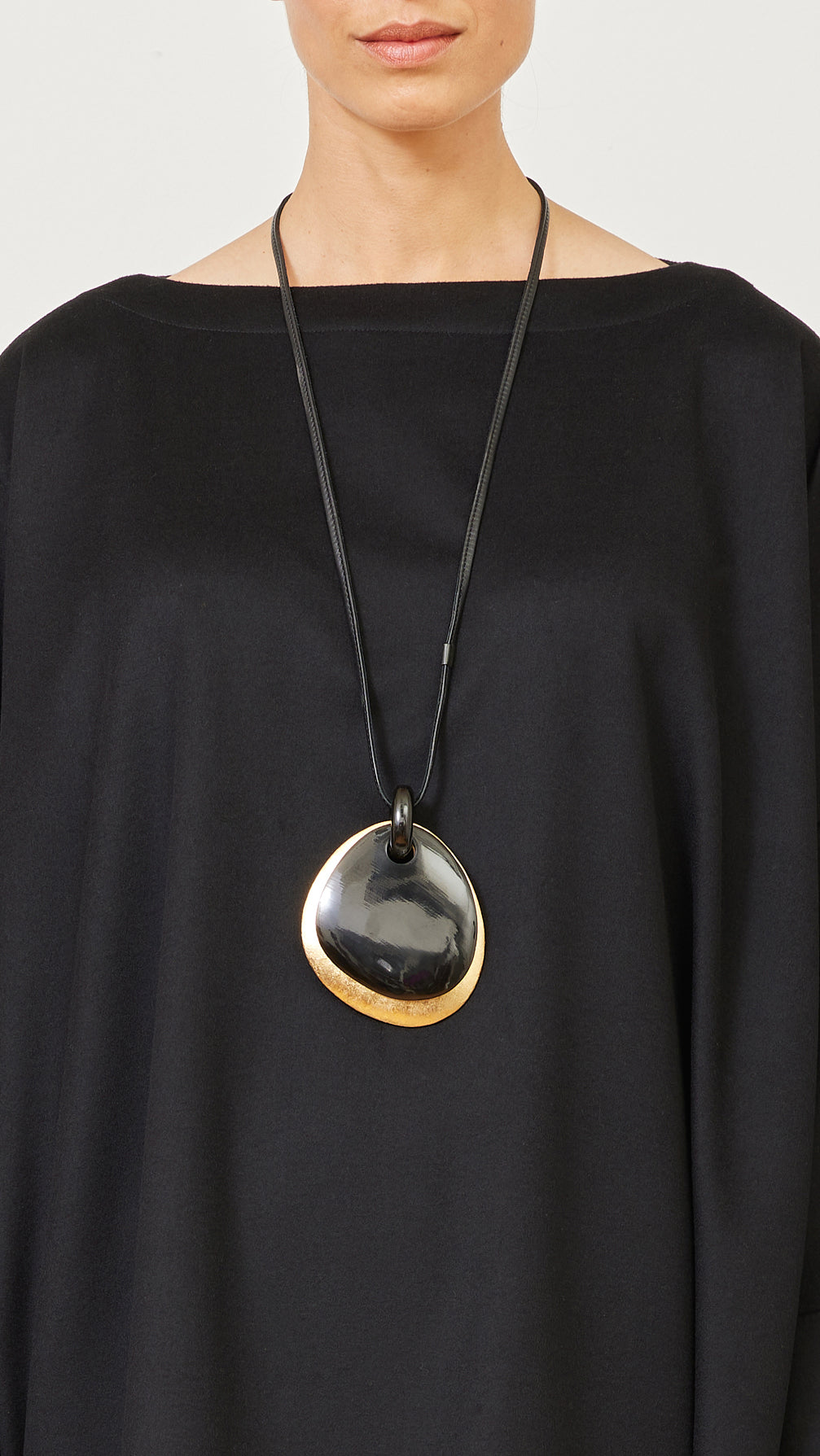 two part elliptical black and gold pendant